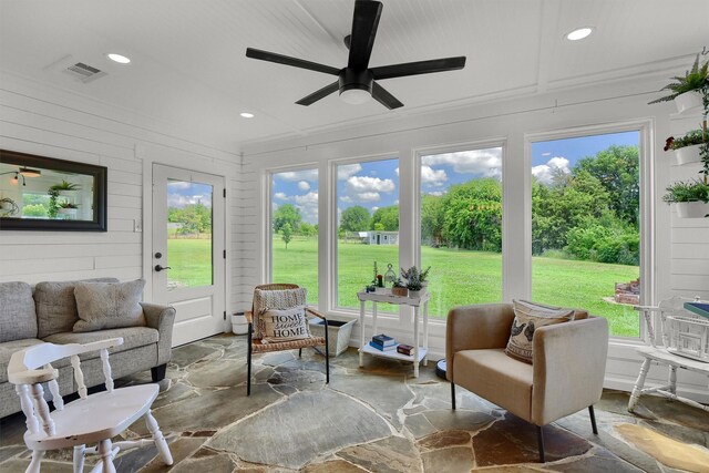 sunroom with ceiling fan and a healthy amount of sunlight