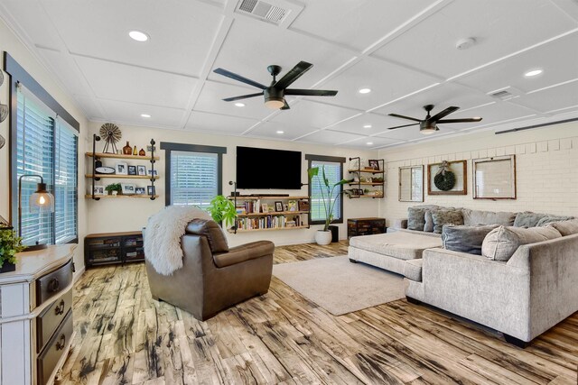 living room with ceiling fan, coffered ceiling, and hardwood / wood-style flooring