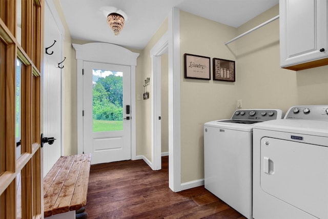 laundry area with cabinet space, baseboards, washer and clothes dryer, and dark wood finished floors