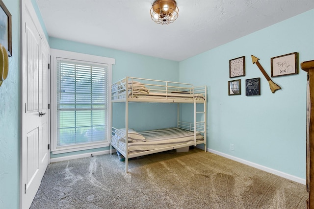 carpeted bedroom with baseboards