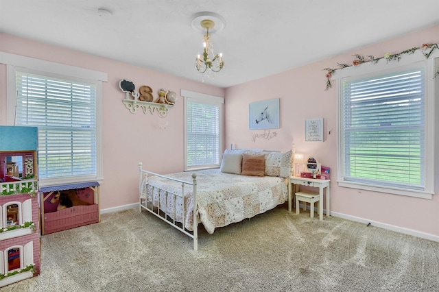 carpeted bedroom with an inviting chandelier