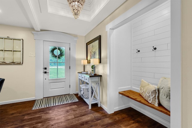 entrance foyer with baseboards, a chandelier, dark wood-style flooring, and beamed ceiling