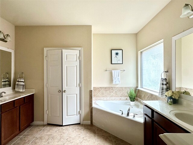 bathroom featuring a tub, tile patterned flooring, and vanity