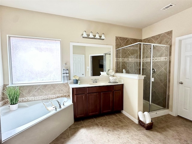 bathroom with tile patterned flooring, vanity, and shower with separate bathtub