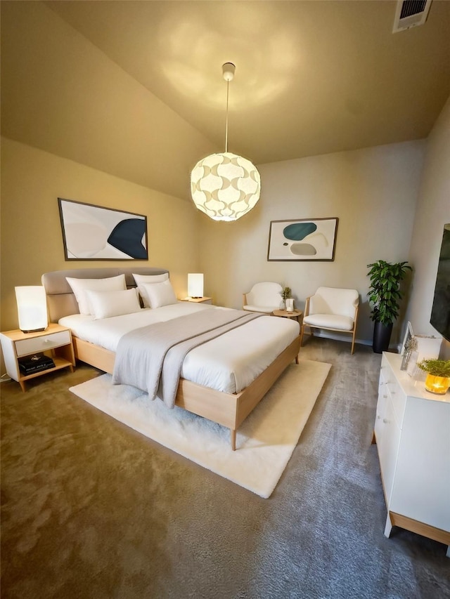 bedroom with dark colored carpet and vaulted ceiling