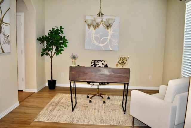 office featuring hardwood / wood-style flooring and an inviting chandelier