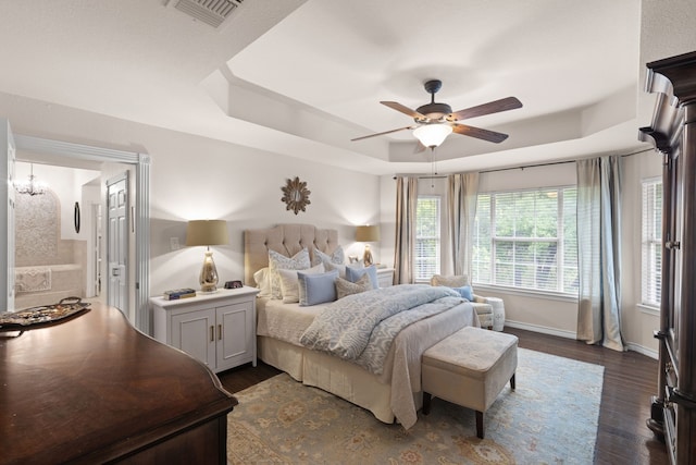 bedroom with baseboards, visible vents, a raised ceiling, a ceiling fan, and dark wood-style floors