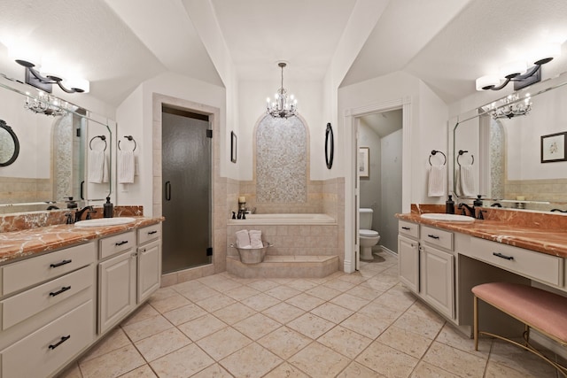 bathroom with toilet, a notable chandelier, a sink, and a bath