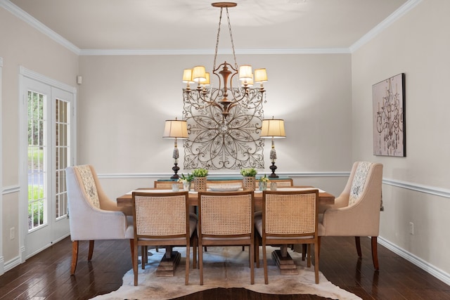 dining room with a notable chandelier, crown molding, baseboards, and dark wood-style flooring