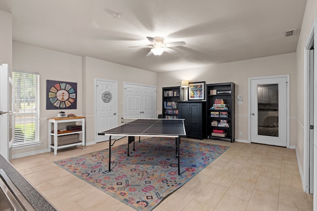 rec room featuring ceiling fan, visible vents, and baseboards