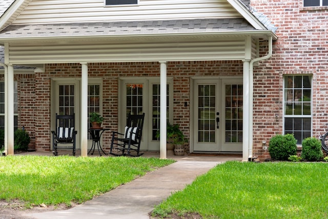 doorway to property with roof with shingles and french doors