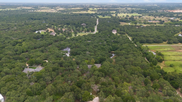 birds eye view of property with a view of trees