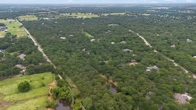 birds eye view of property featuring a wooded view