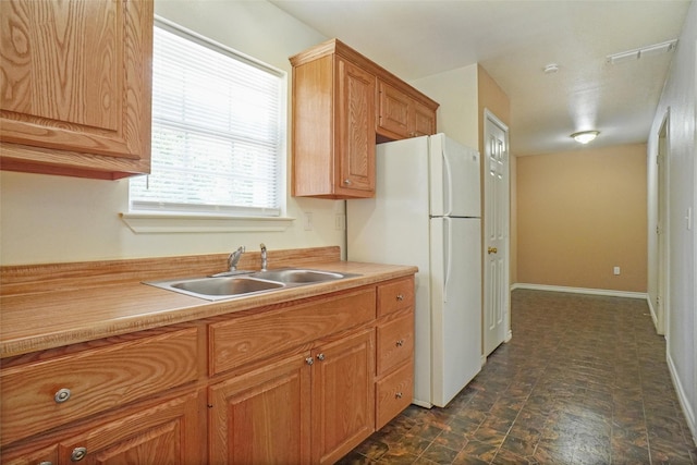 kitchen with sink and white fridge