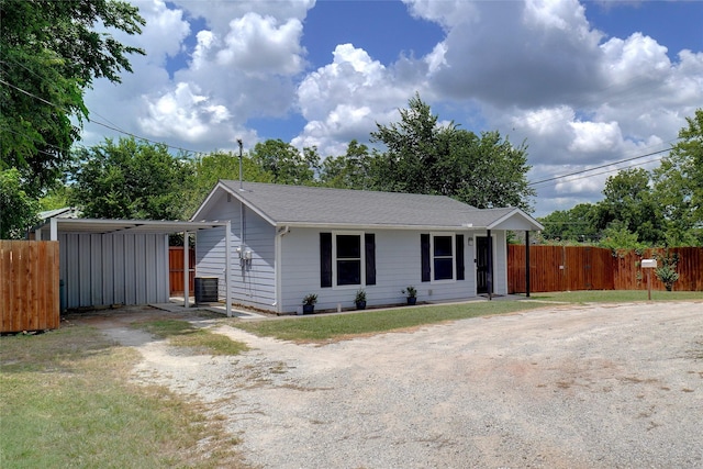 single story home with a carport and central air condition unit