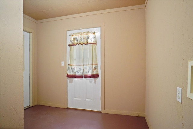 doorway to outside with concrete floors