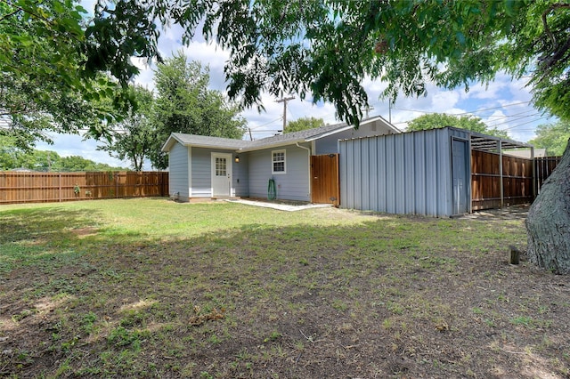 rear view of house with a yard