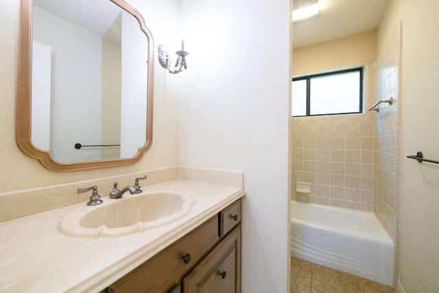 bathroom featuring tile patterned floors, vanity, and tiled shower / bath