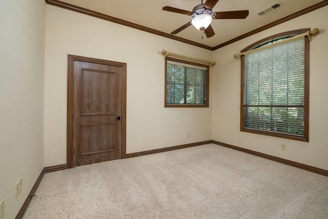 unfurnished room with light carpet, ceiling fan, and ornamental molding