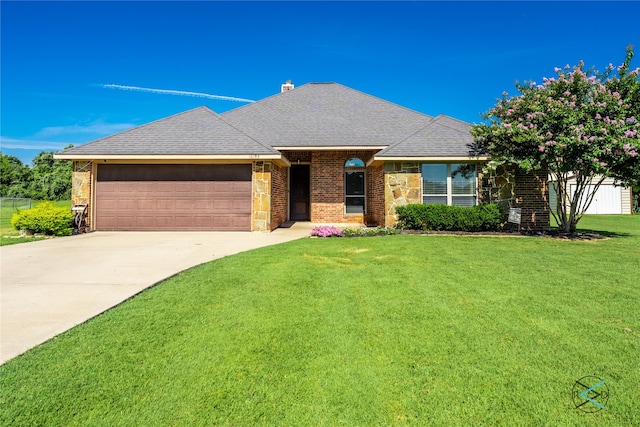 view of front of property with a garage and a front lawn