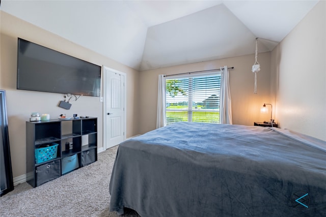 carpeted bedroom featuring vaulted ceiling