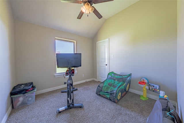 exercise room featuring ceiling fan, carpet floors, and vaulted ceiling