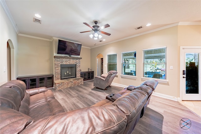 living room with plenty of natural light, ceiling fan, light hardwood / wood-style flooring, and a fireplace