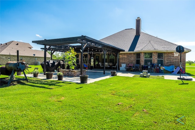 rear view of house with a patio, a lawn, and a pergola