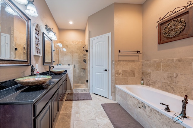 bathroom featuring tile floors, dual vanity, and shower with separate bathtub