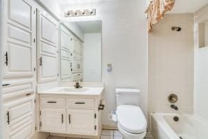 full bathroom with vanity, bathing tub / shower combination, and toilet