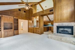 unfurnished living room with beamed ceiling, ceiling fan, light colored carpet, and high vaulted ceiling