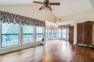 unfurnished living room with vaulted ceiling, hardwood / wood-style floors, and ceiling fan