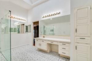 bathroom with vanity and tiled shower