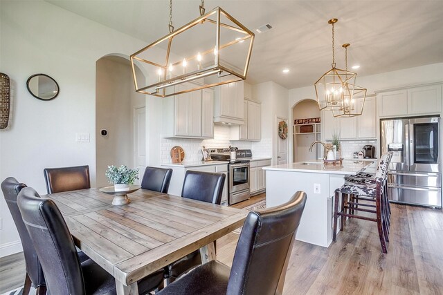 dining space featuring sink and light hardwood / wood-style flooring