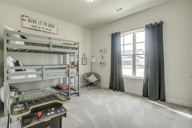 carpeted bedroom with multiple windows