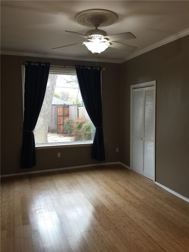 unfurnished bedroom with ceiling fan, light hardwood / wood-style flooring, and ornamental molding