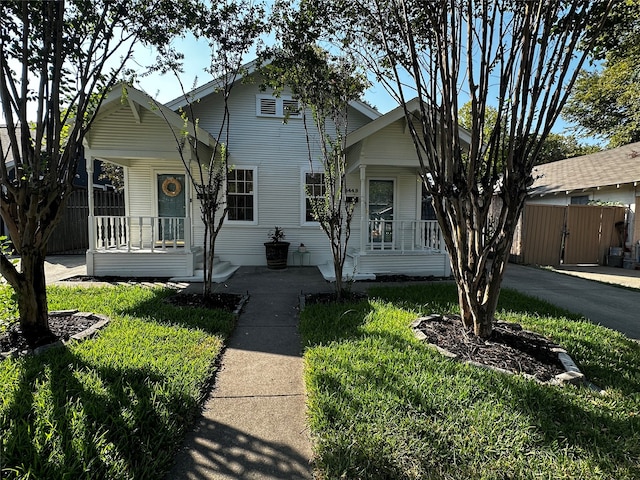 view of front of home with covered porch and a front yard