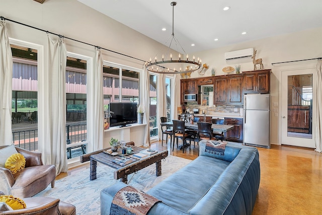 living room with an AC wall unit and a notable chandelier