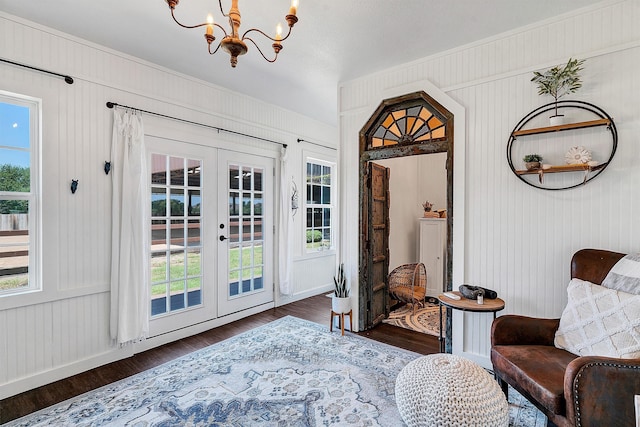 interior space with dark wood-type flooring, french doors, and an inviting chandelier