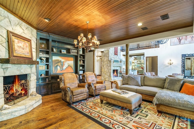 living room featuring a stone fireplace, built in features, a chandelier, hardwood / wood-style flooring, and wooden ceiling