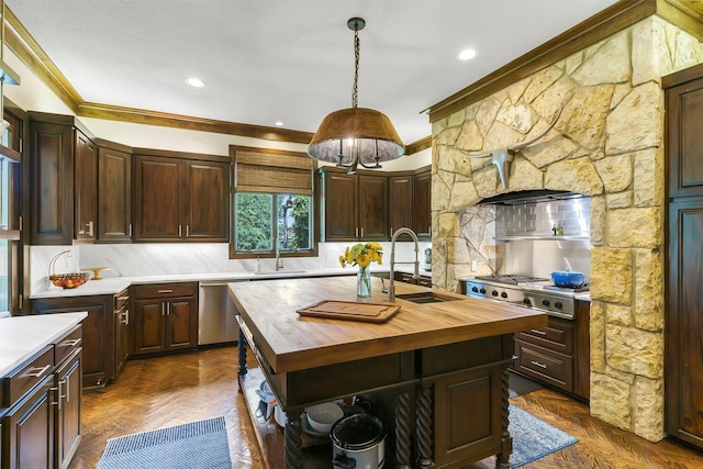 kitchen with decorative light fixtures, sink, a kitchen island with sink, dark parquet floors, and butcher block countertops