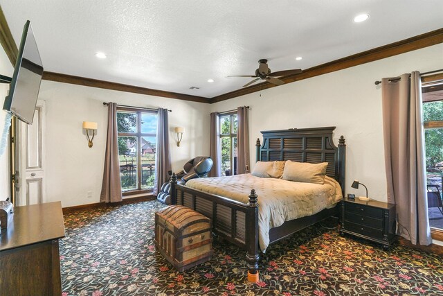 carpeted bedroom with ceiling fan, multiple windows, ornamental molding, and a textured ceiling