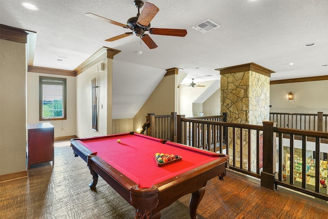 rec room with a textured ceiling, pool table, ornamental molding, and dark colored carpet