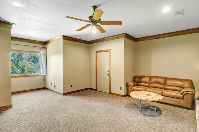 living room with ceiling fan, a textured ceiling, and ornamental molding