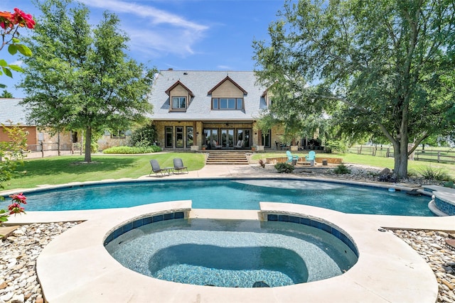 view of swimming pool with an in ground hot tub and a lawn