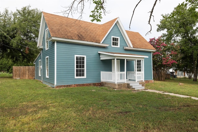 view of front of property with a porch and a front lawn