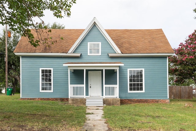 view of front of house with a porch and a front yard