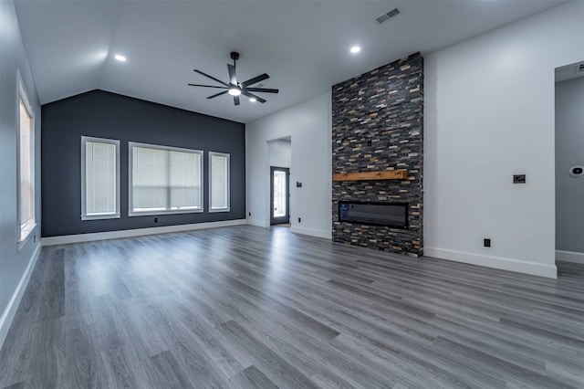 unfurnished living room featuring ceiling fan, hardwood / wood-style flooring, a fireplace, and lofted ceiling