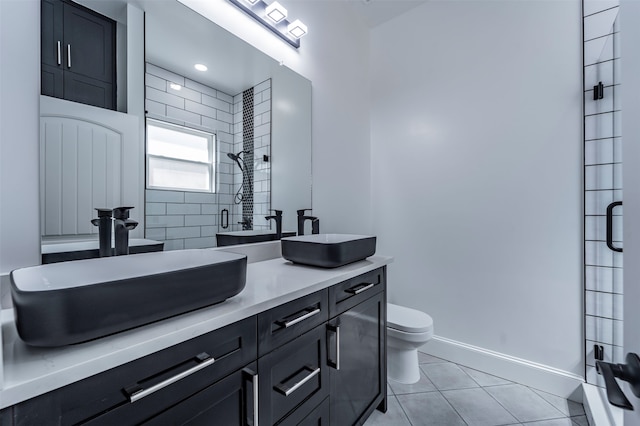 bathroom with tile flooring, walk in shower, vanity, and toilet