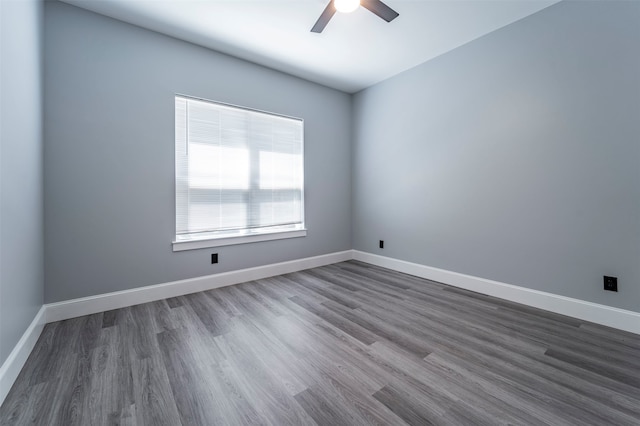 spare room featuring ceiling fan and dark hardwood / wood-style flooring